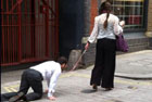 Woman takes man out for a walk... on a leash in London